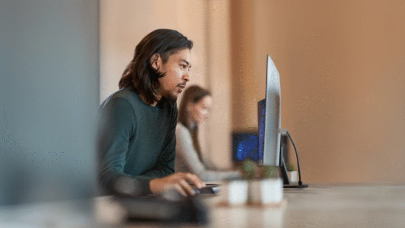 Enterprise office worker in focused work with a positive facial expression.