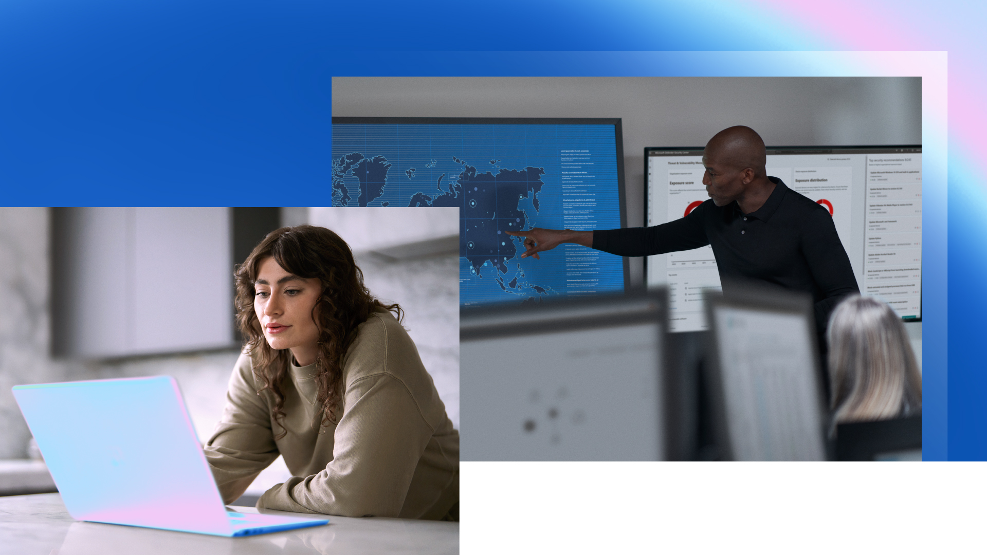 Two people points at computer screens.