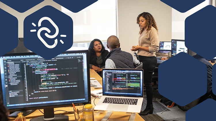 Photo of developers discussing with the hexagon and the supply chain attack icon in overlay