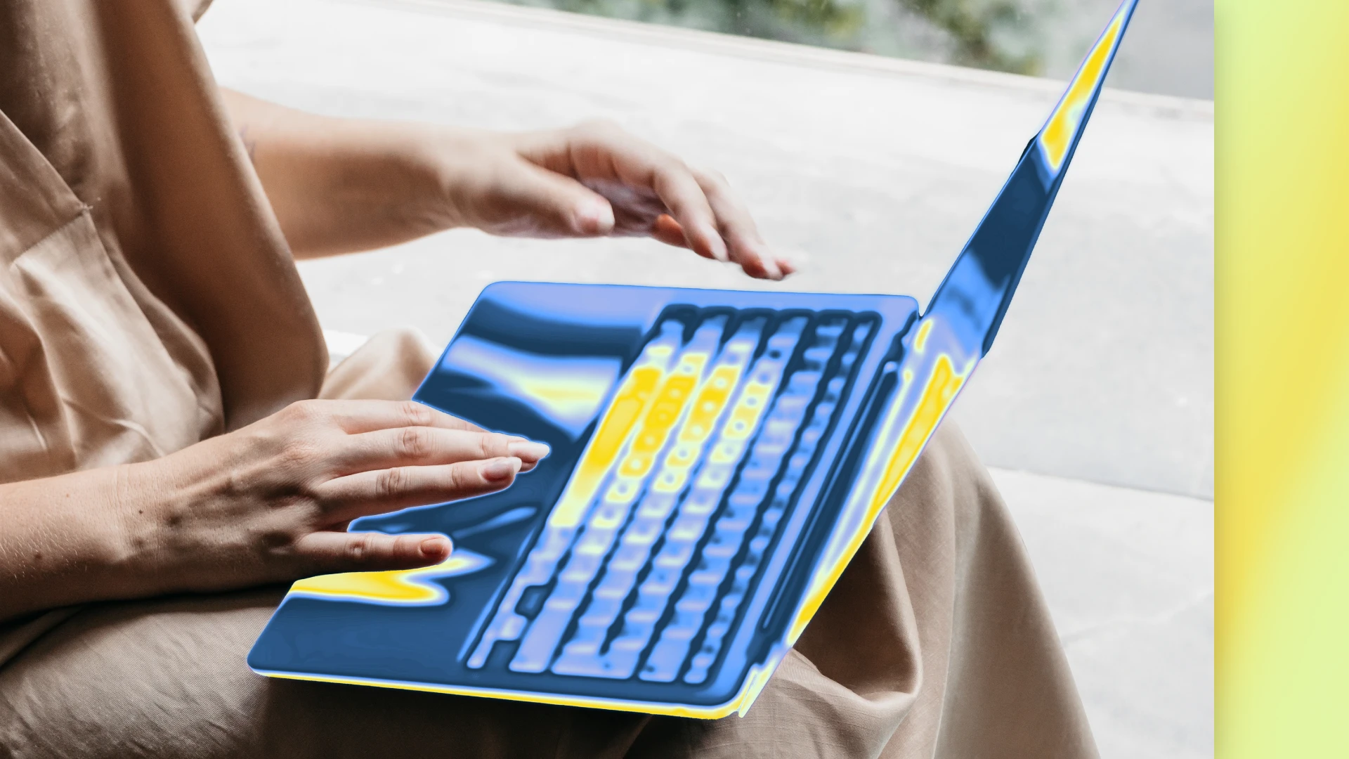 Close up photograph of hands typing on a laptop.