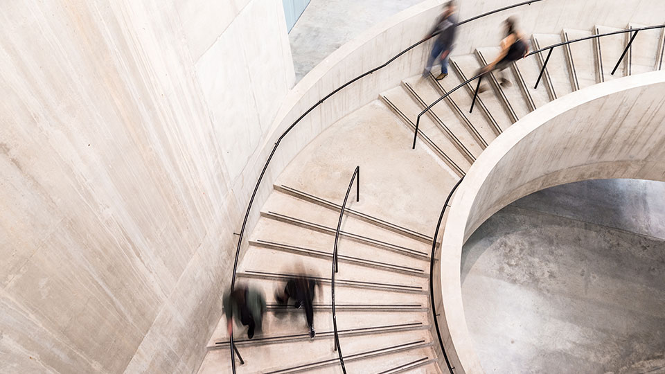 An abstraction of people walking down a staircase