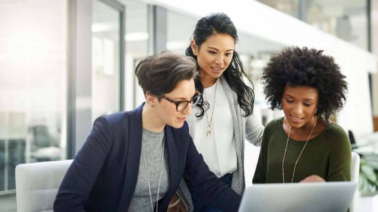 Group of businesswomen using a laptop during a meeting at work