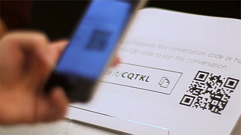 a mobile phone is scanning a QR code to join a live conversation in the Translator app