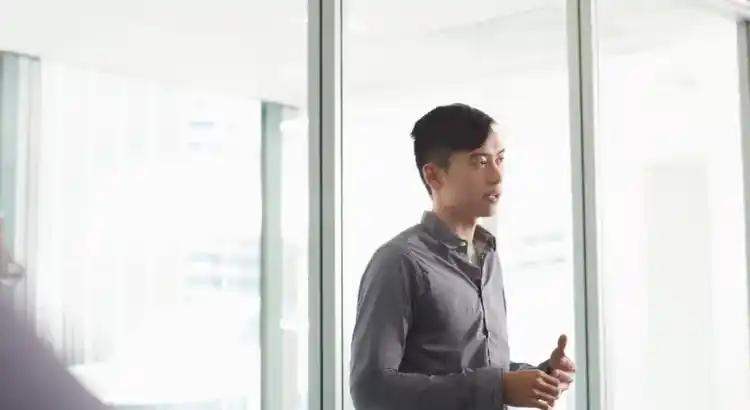 A picture of a person standing near a window