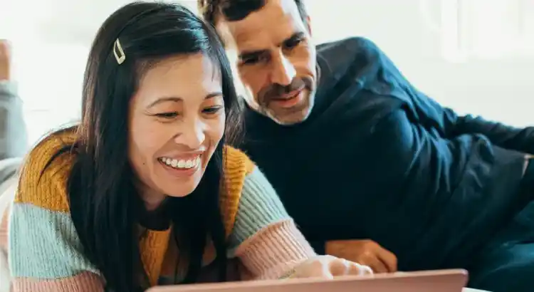 Two people watching something on a tablet