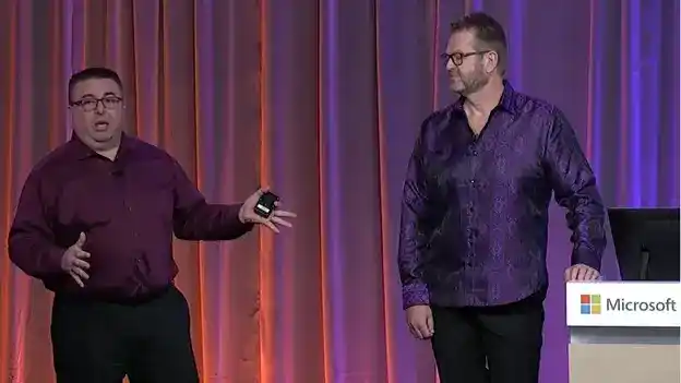 A picture of two people on stage