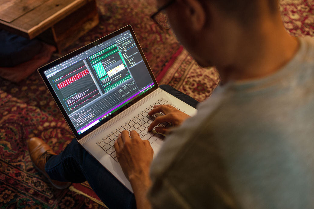 A man using his laptop at home.