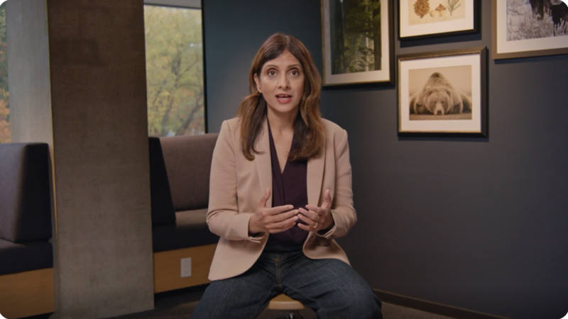 Woman sitting in front of a camera in an office surrounding