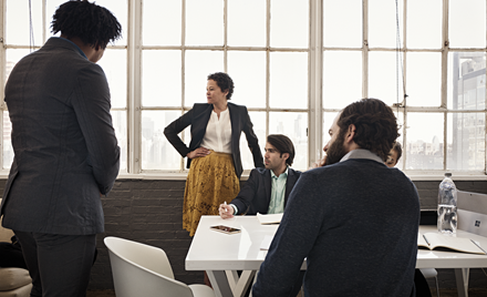 Image for: A group meets around a table in a meeting room.