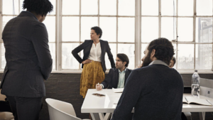Business men and women in conference room.