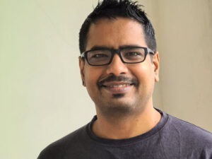 Sahoo looks at the camera in a corporate photo. 