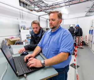 Mike Shepperd and Samuel Ogden stand in the power substation.