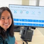 Lau sits at a desk with the vision and goals of a new SIEM on the screen.