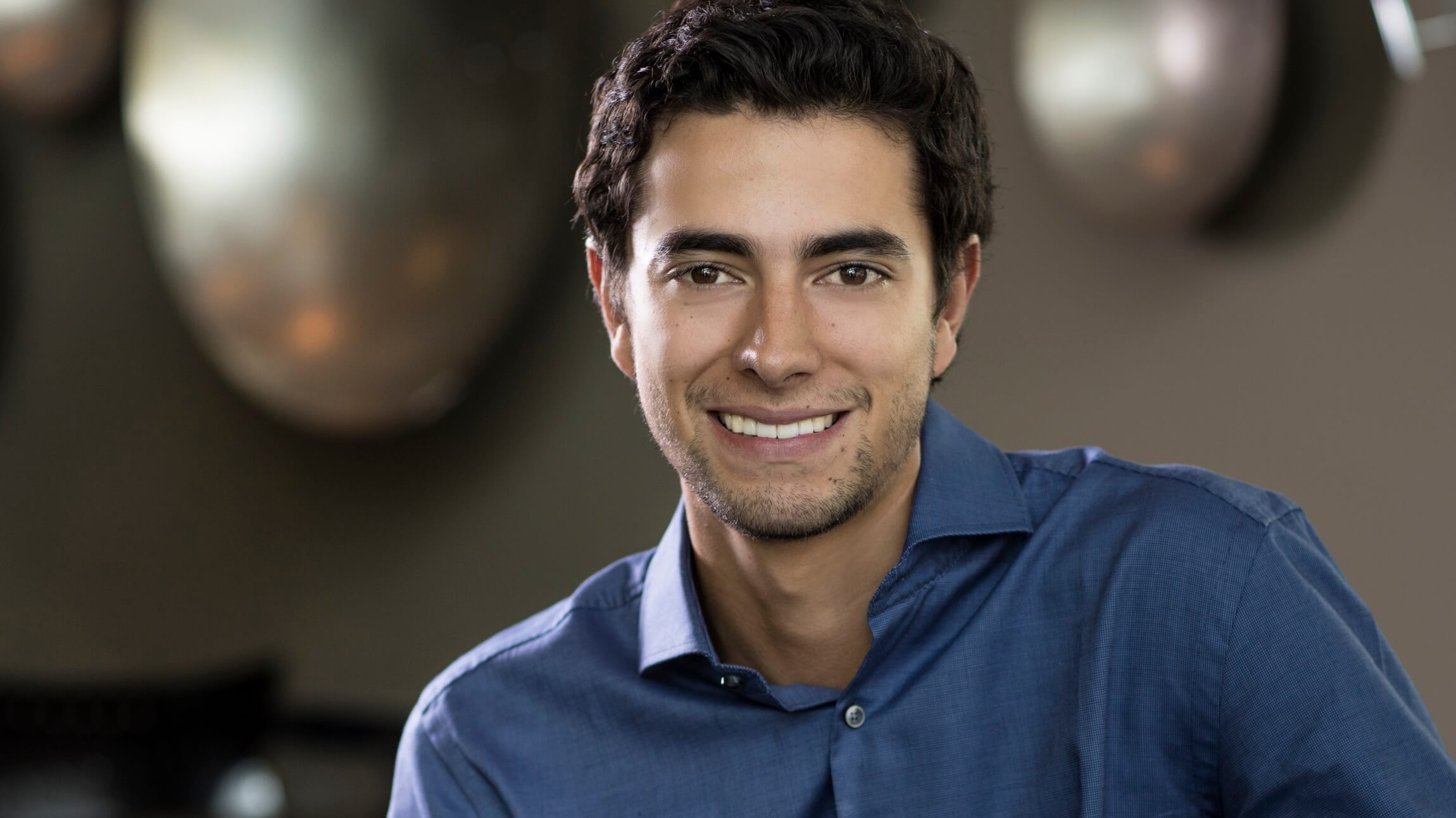 Hidalgo smiles in a corporate profile photo.