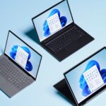 Three devices are arranged in a triangle with each showing a Windows 11 homepage.