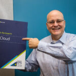 Apple poses for a photo holding a “cloud expert” placard.