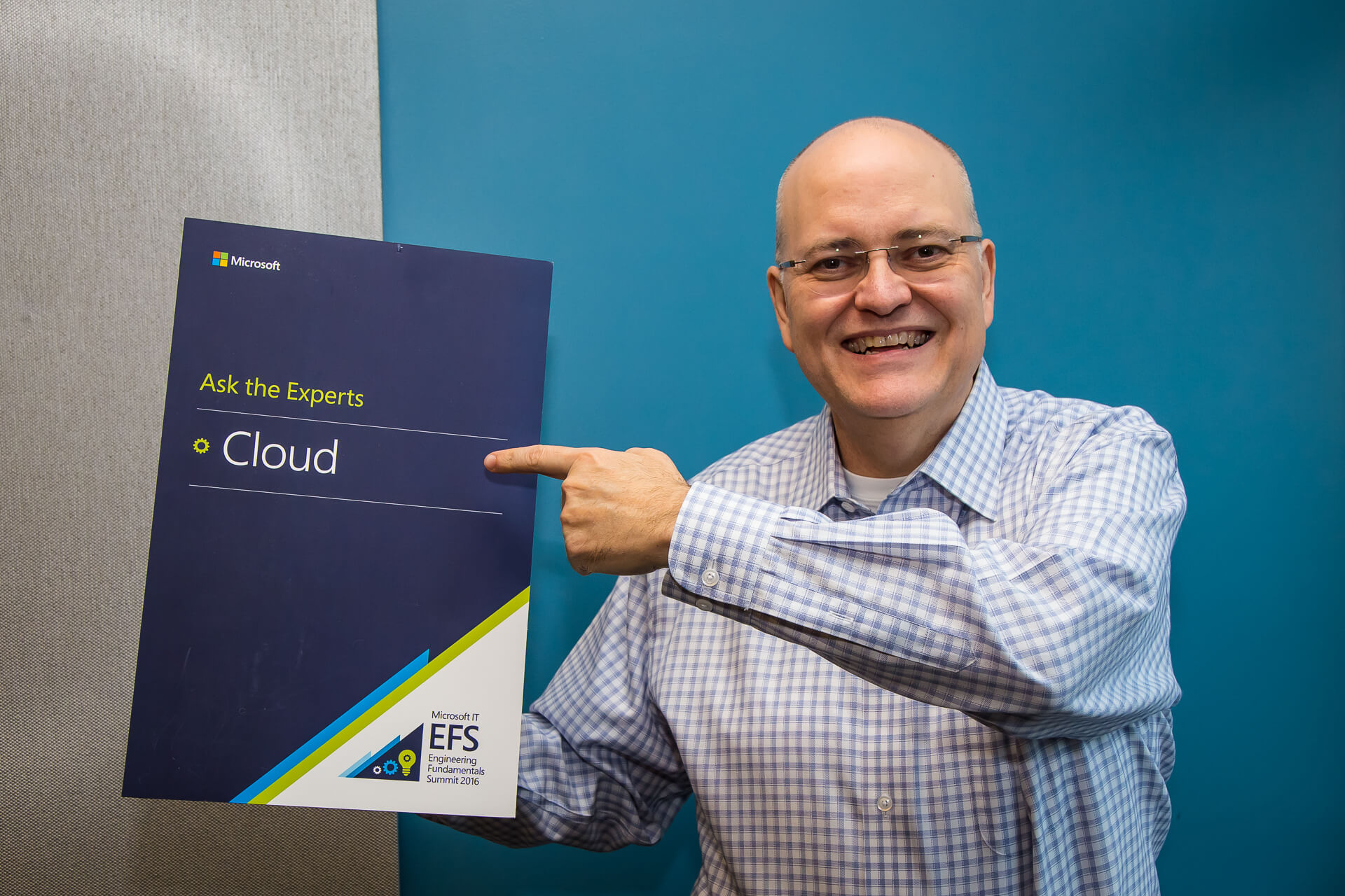 Apple poses for a photo holding a “cloud expert” placard.