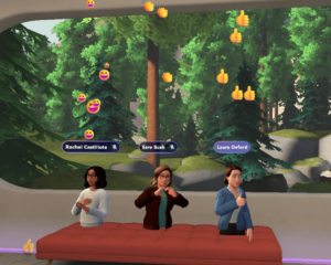 A screenshot of the immersive spaces environment showing three different avatars displaying emojis and reactions.