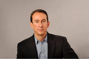 Fernandez smiles in a corporate photo.