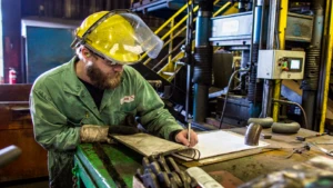 Worker in factory reviewing plans