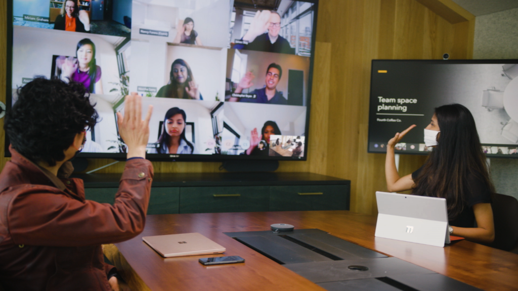 Image showing people collaborating digitally and in-person with Breakout rooms from Microsoft Teams 