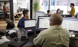 Image of an office of tech workers using Microsoft Office products.