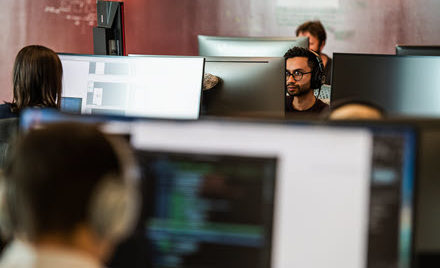 Image of a worker behind his desktop PC.