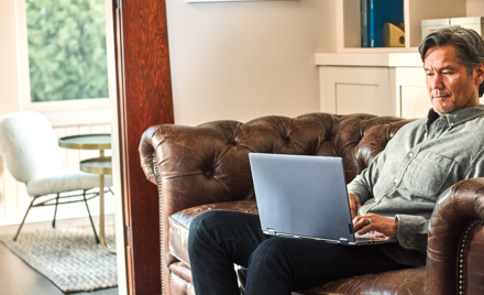 Man interacting with a Leno Yoga laptop.