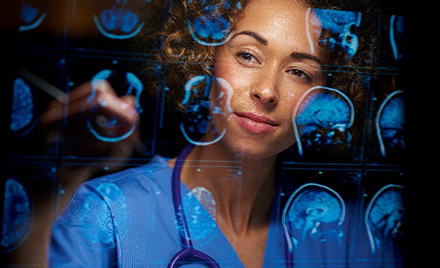 Image for: Image of a neurosurgeon looking at scans on a computer screen.