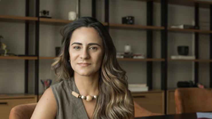 Woman sitting in an office facing the camera shot