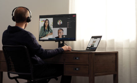 Image for: Teams call with headphones at a home desk on a Lenovo ThinkPad X1 Carbon.